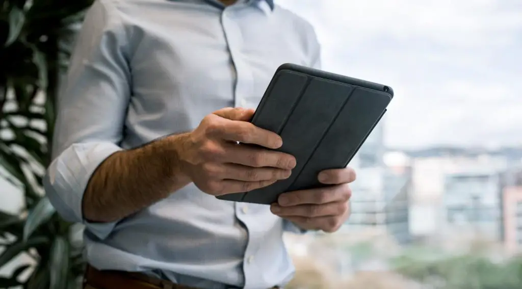 Man Using Tablet in Hand