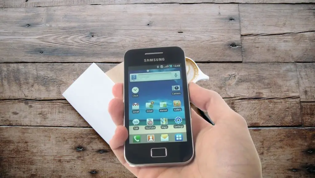 Samsung Galaxy Ace mobile Home Screen in hand