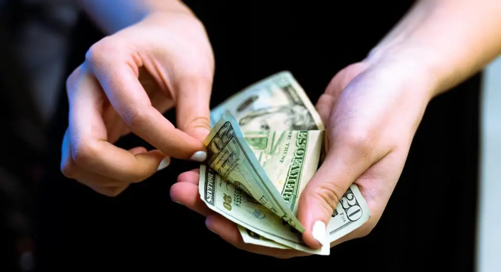 Woman Counting Money with Fingers