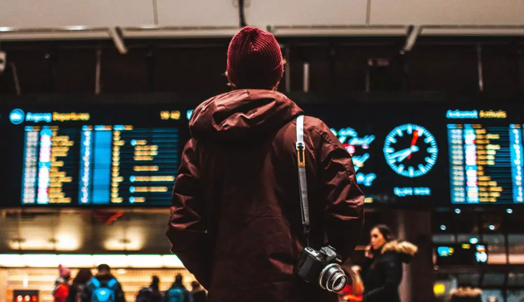 Person Watching Flight Schedule in Airport