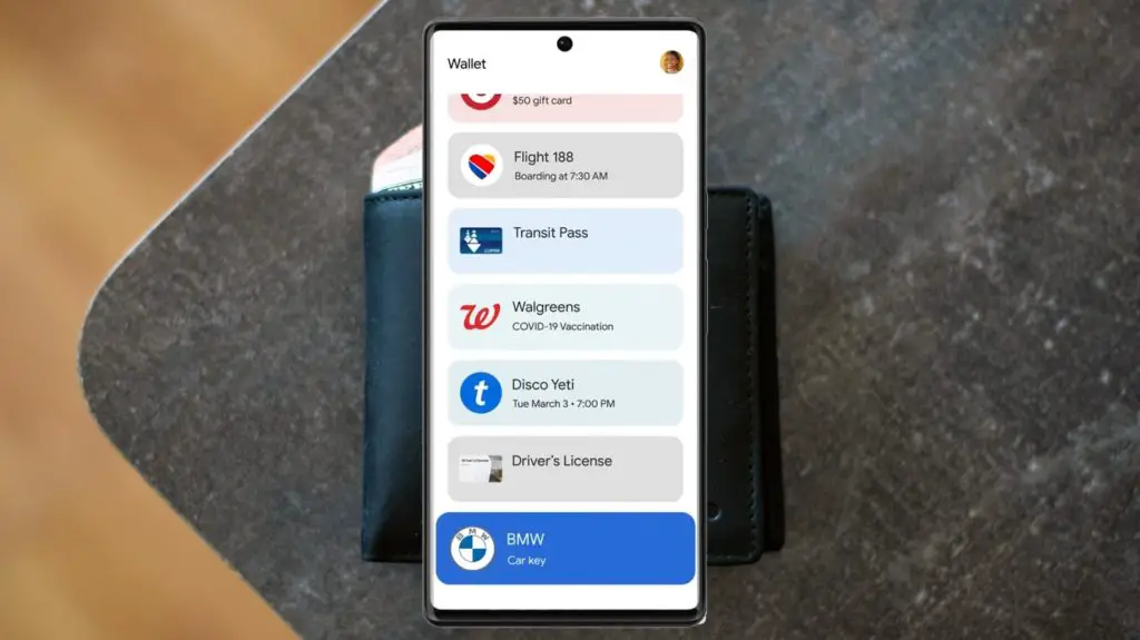 Google Wallet App Infront of Real Wallet